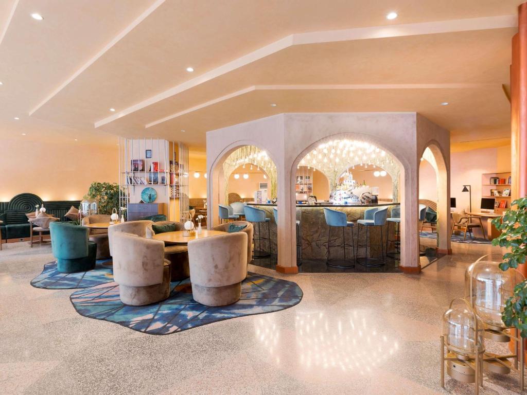 a hotel lobby with a table and chairs at Mercure Istanbul Bakirkoy in Istanbul