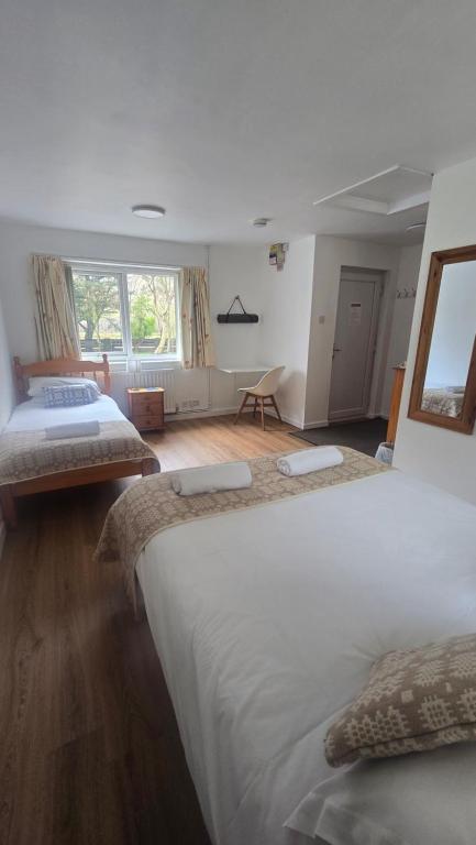 a bedroom with two beds and a living room at Snowdonia Mountain Lodge in Bethesda