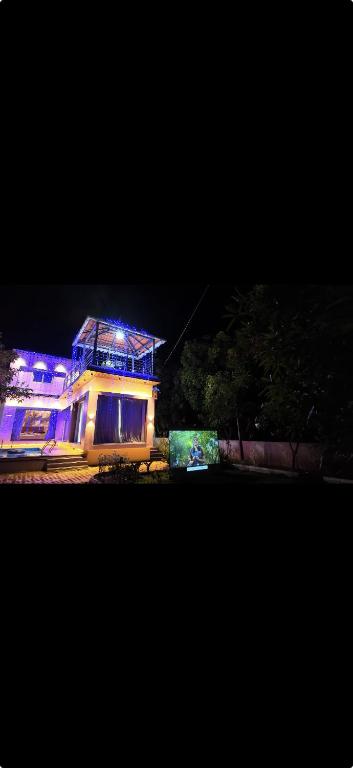 a house lit up at night with blue lights at La reve ecr , Panaiyur in Chennai