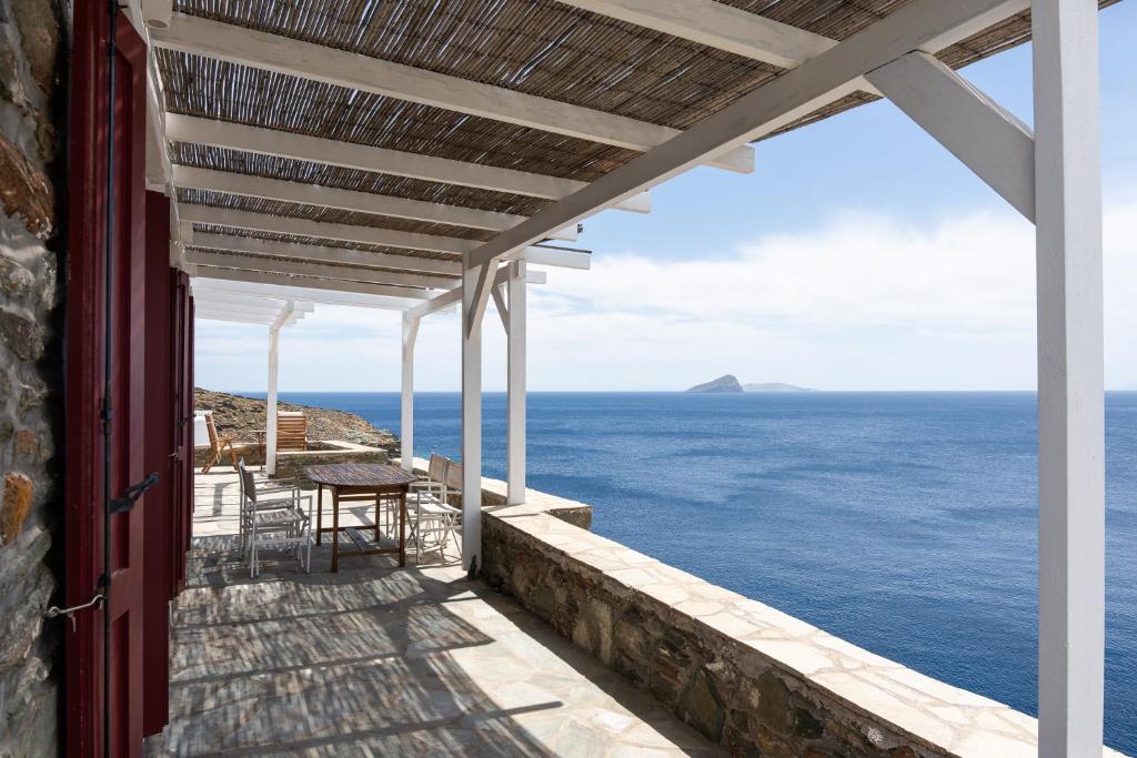 a view of the ocean from the porch of a house at Nalo Suites & Villas in Kithnos