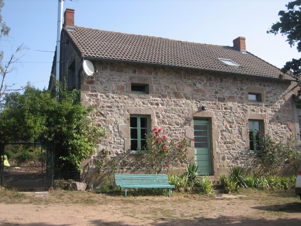 a stone house with a green bench in front of it at "La Résistance" proche du Pal in Loddes