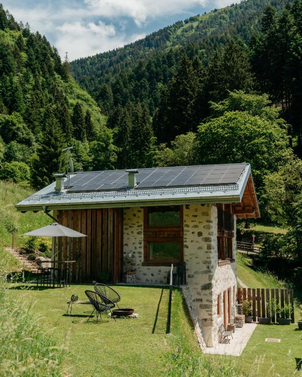 a house with solar panels on the side of it at Chalet Noèr in Ledro