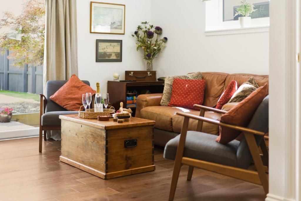 a living room with a couch and a table at 20 Applegrove in Monifieth