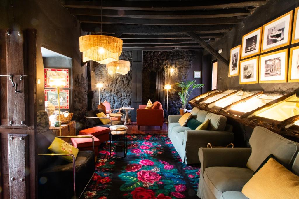 a living room with couches and chairs in a room at Maison Conde de la Cebada in Ampudia