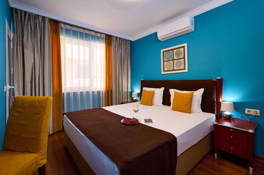 a hotel room with a bed and a chair at Art Green Boutique Hotel in Varna City