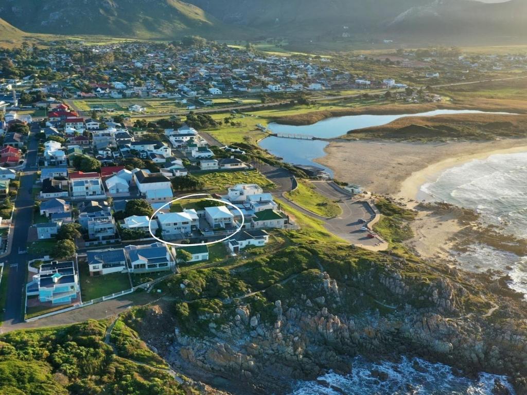 an aerial view of a beach with houses at Footprints in Kleinmond in Kleinmond