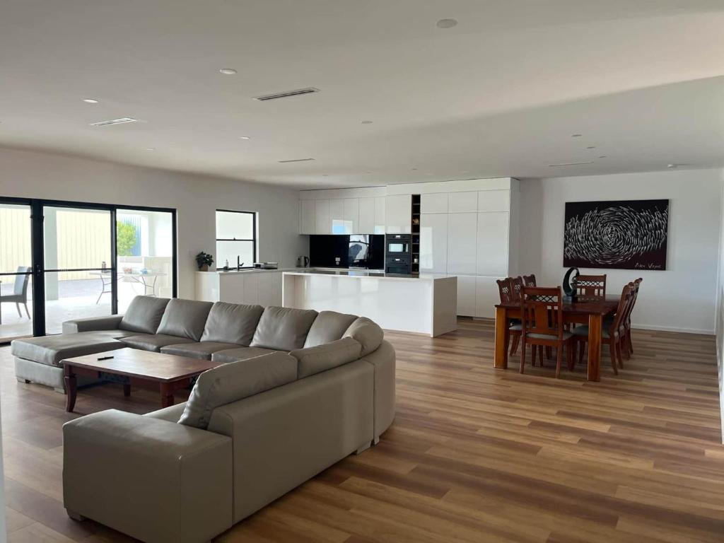 a living room with a couch and a table at Moonta Bay Hideaway in Port Moonta