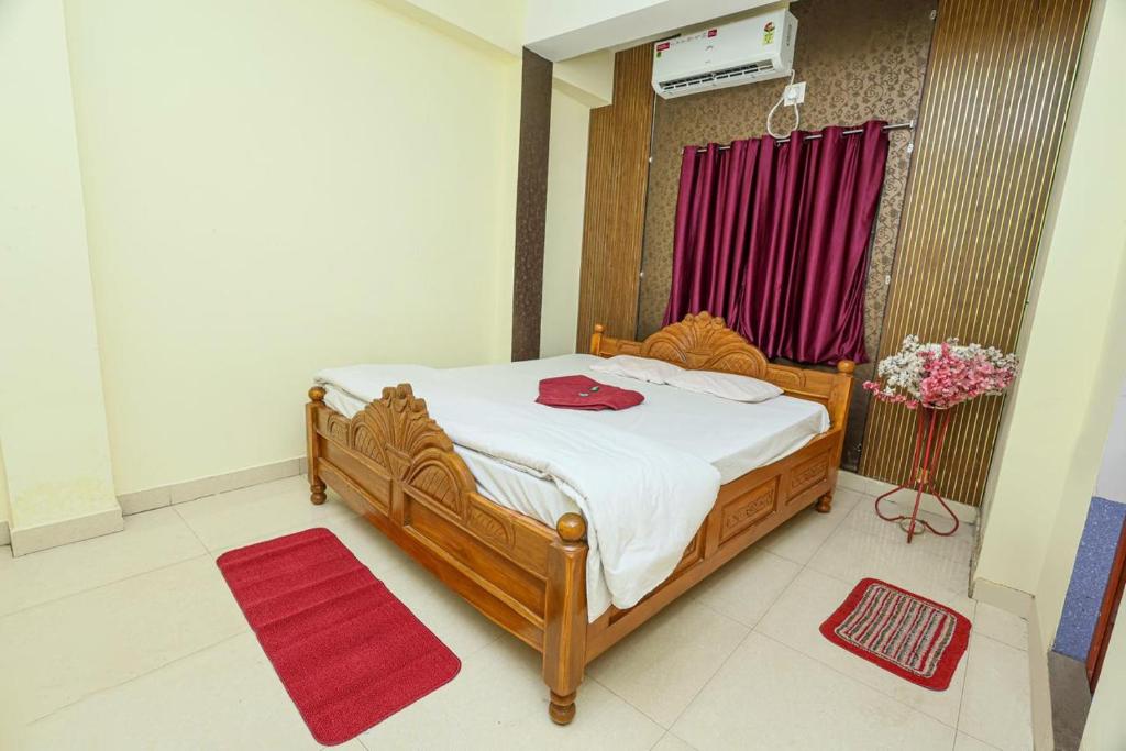 a bedroom with a bed with a red towel on it at Silver residency in Bhubaneshwar