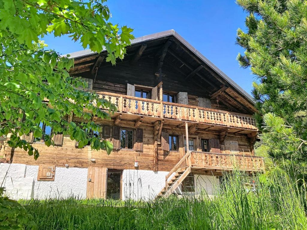 a log cabin with a deck on the side of it at Chalet Chalet Anthamatten-3 by Interhome in Champéry
