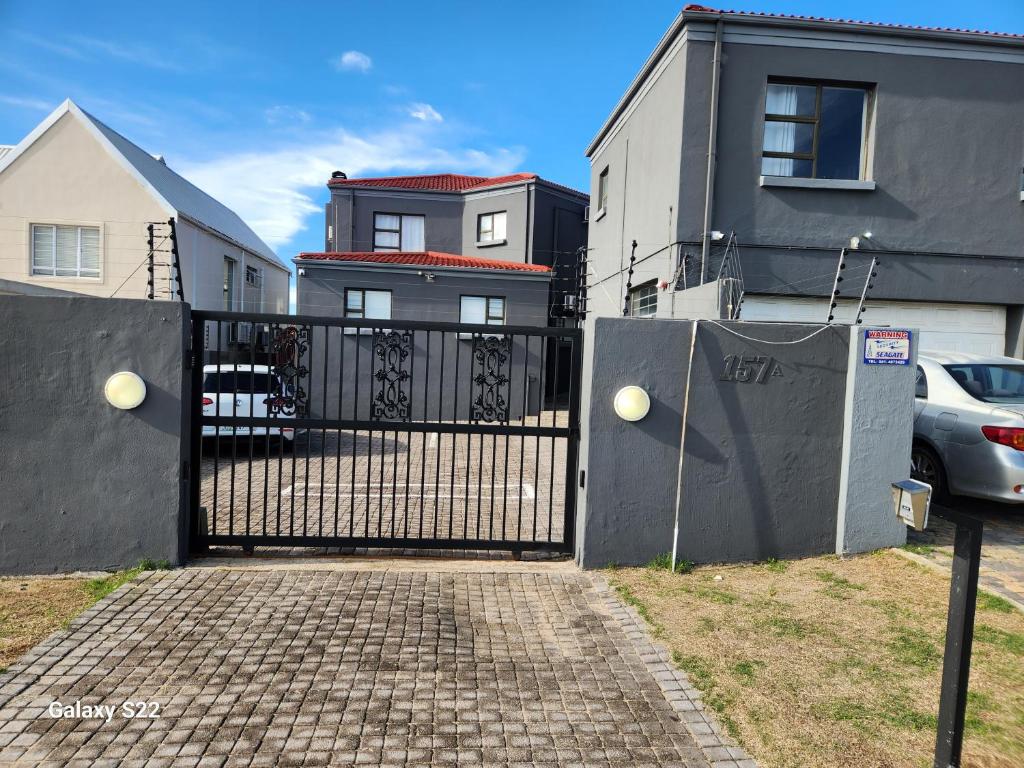 a black gate in front of a house at Pado B & B in Gqeberha