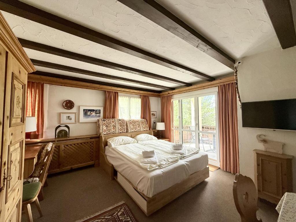 a bedroom with a bed and a large window at Apartment Residenza Chesa Margun 78-1 by Interhome in Surlej