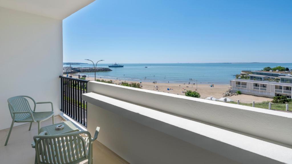 a balcony with a view of the beach at Kyriad - Royan Plage in Royan