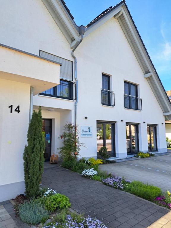 a white house with a lot of windows at Pension Yvonne - SUPERIOR - am Europa-Park in Rust