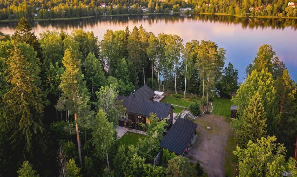 an aerial view of a house on the shore of a lake at Stay North - Peikkola in Kirkkonummi