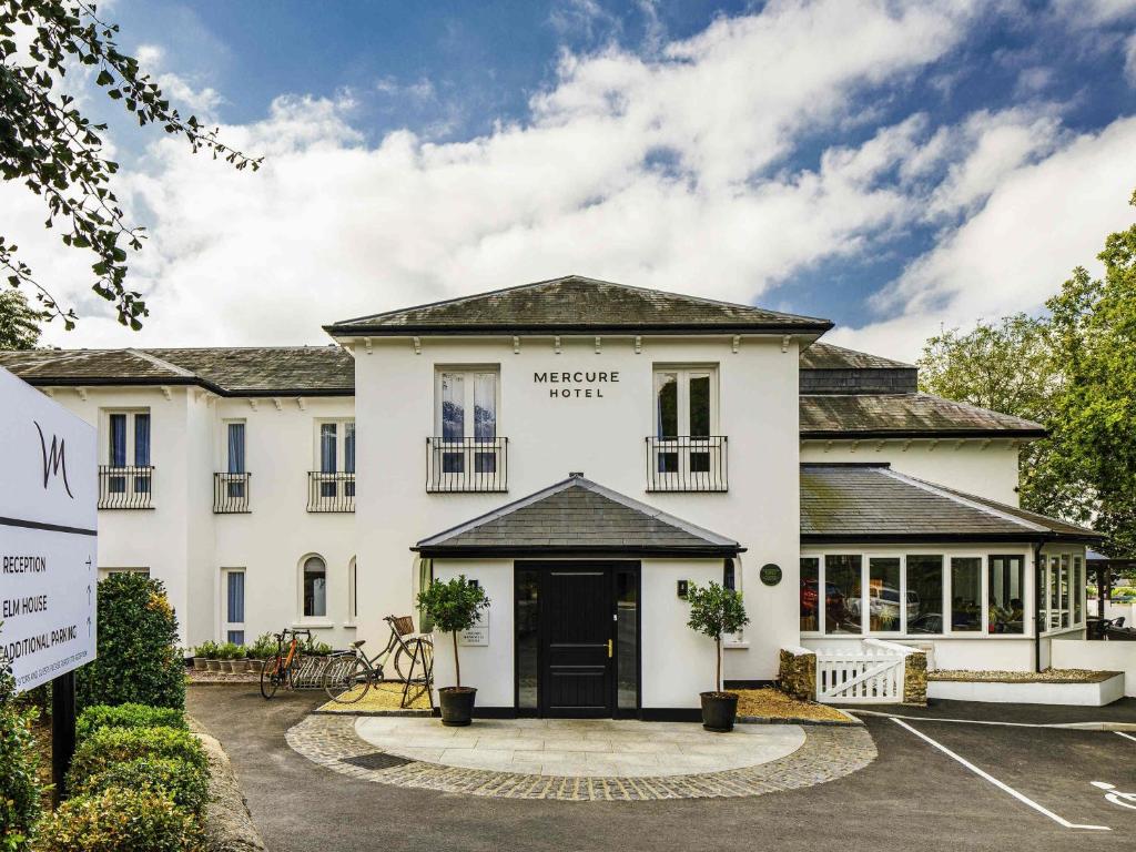 a large white building with the front entrance to the morpheus hotel at Mercure Oxford Hawkwell House Hotel in Oxford
