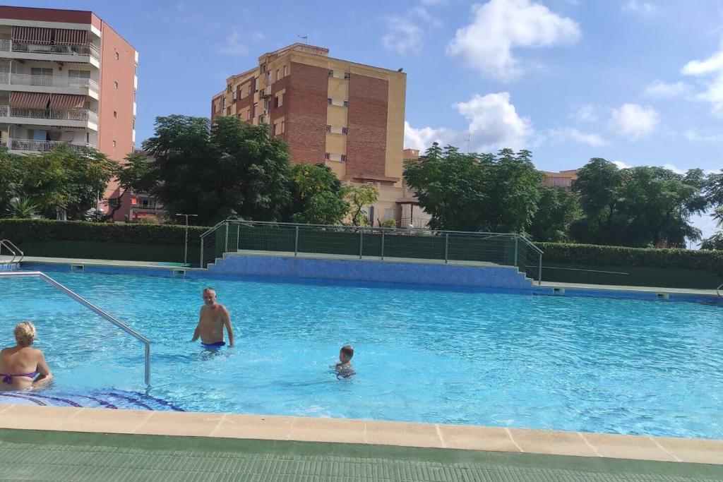 a group of people in a swimming pool at Promar La Pineda Port Aventura in La Pineda