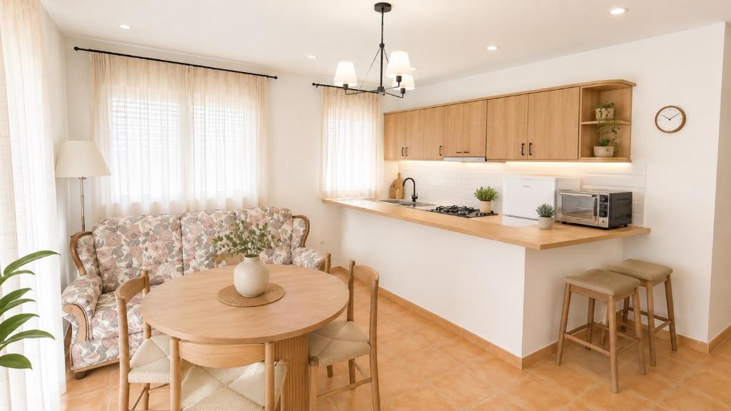 a kitchen and a living room with a table at Poseidón in Quesada