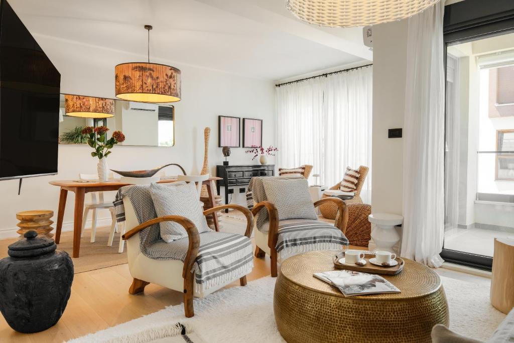 a living room with a couch and chairs and a table at Luxurious Bohemian Residence with Pool in Tivat