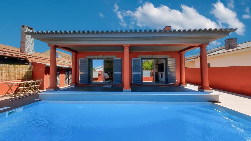 a villa with a swimming pool on a house at Solstice Villa Private Pool & BBQ Cascais in Alcabideche