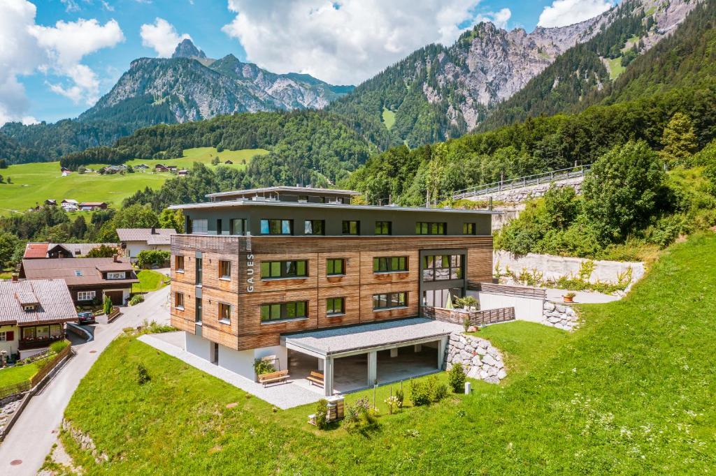an aerial view of a building with mountains in the background at Haus Gaues in Dalaas