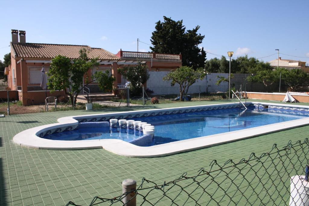 a swimming pool in front of a house at Mi Cielo in Cartagena