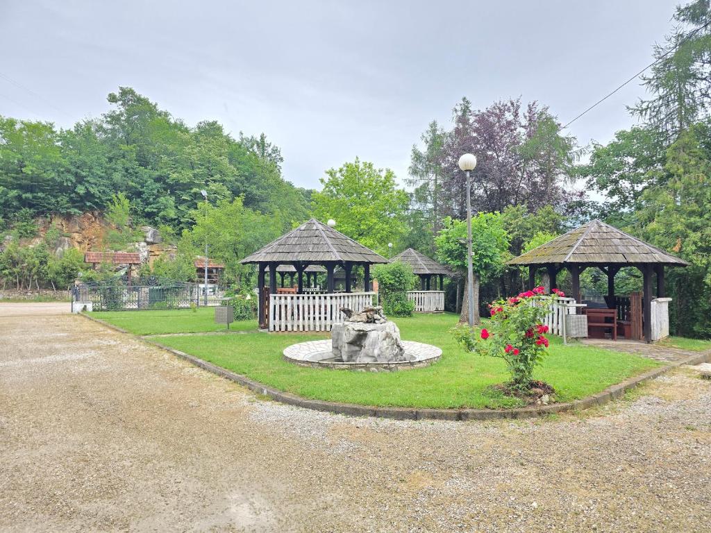 a park with a fountain and a gazebo at Vila PAUN in Doboj