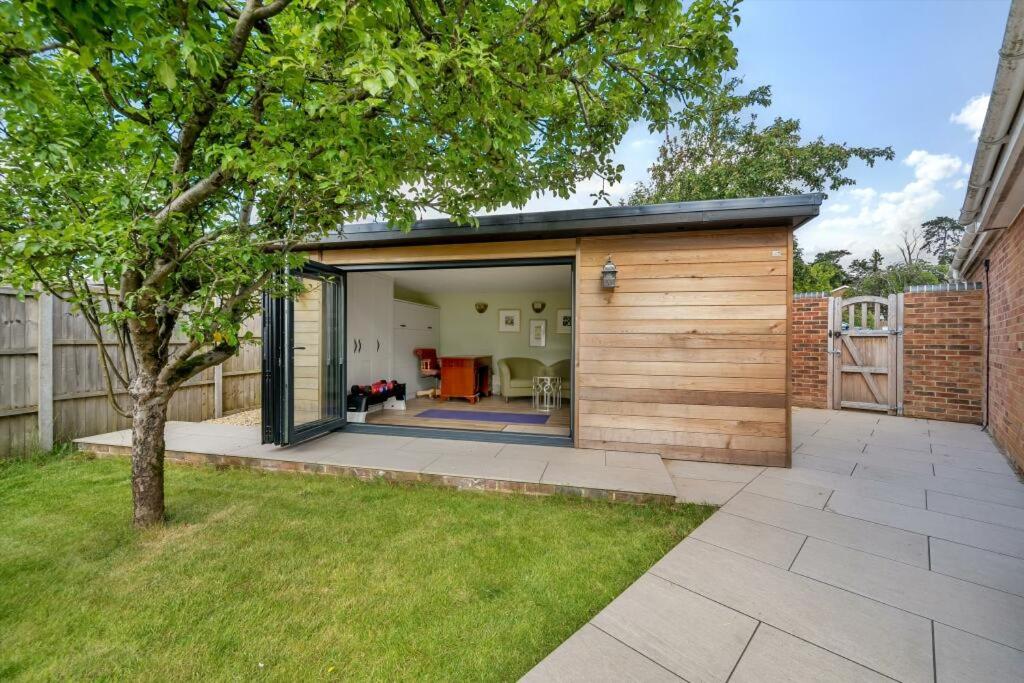 a small house with a sliding glass door at The Garden Studio in Wargrave