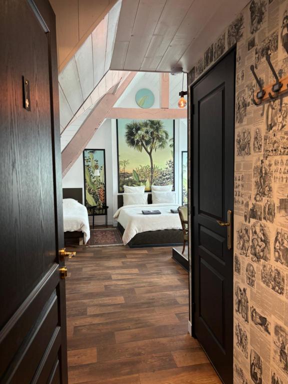 a hallway with a bedroom with a bed and an open door at L'échappée belle in Sixt-sur-Aff