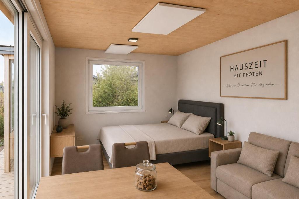 a bedroom with a bed and a couch and a table at Hauszeit mit Pfoten in Litschau