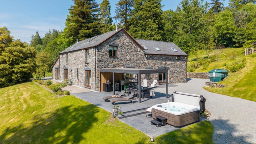 an overhead view of a stone house with a hot tub at Plas Madoc Coach House in Conwy