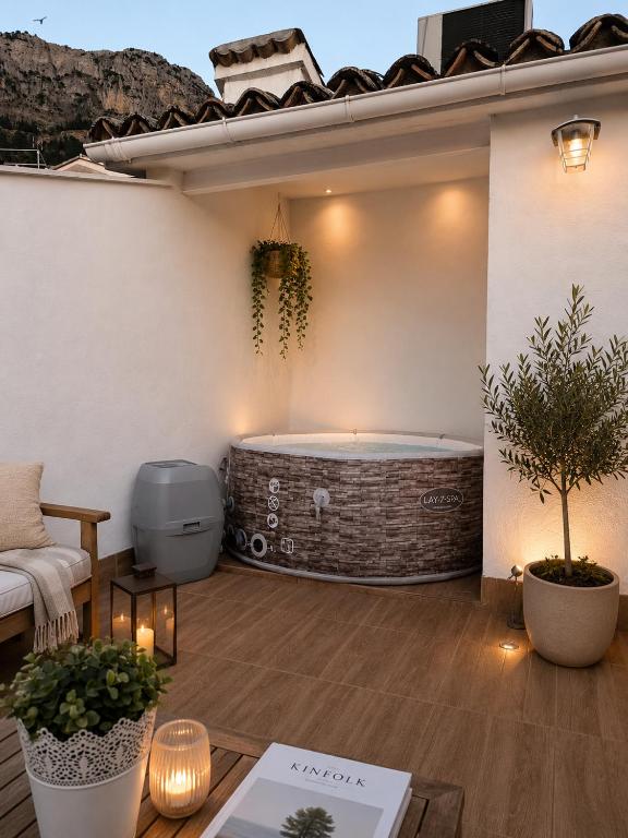 a patio with a jacuzzi tub on a house at Casa Papel y Pluma in Cazorla