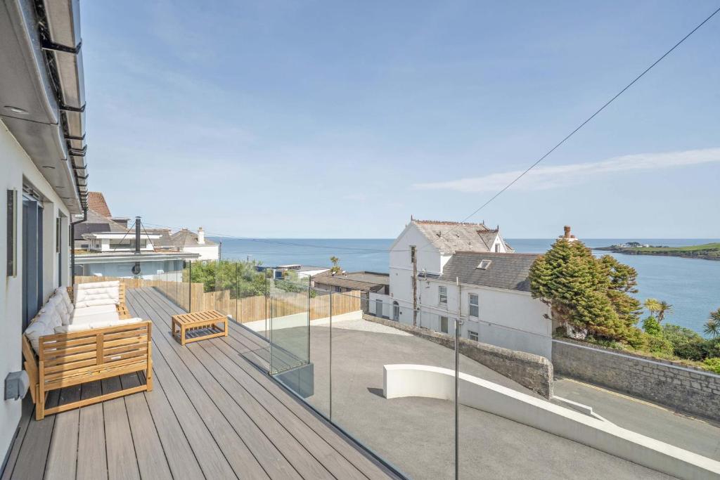 a balcony of a house with a view of the ocean at Seaglass Point in Mevagissey