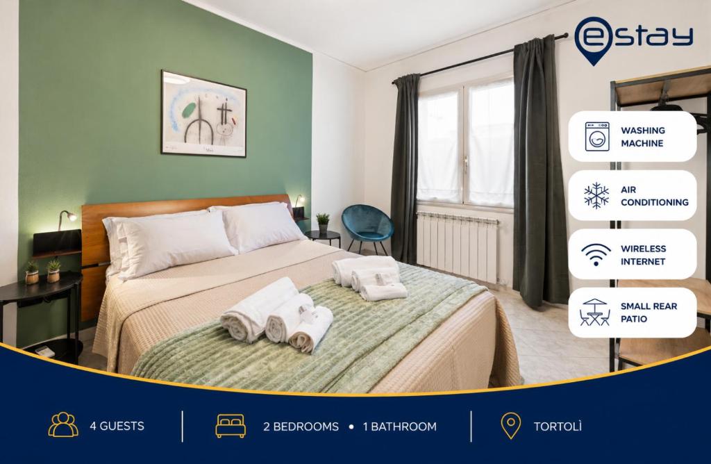 a bedroom with a bed with towels on it at Estay - Casa Bo' in city center - AirCon - WiFi in Tortolì