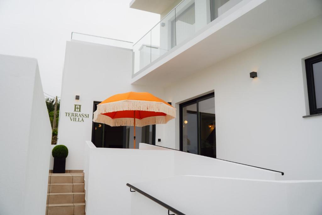 an orange umbrella sitting in the middle of a building at Terrassi Villa in Angra do Heroísmo
