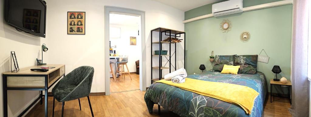 a bedroom with a bed and a table and a desk at Cosy room - centre ville - 2 pers in Sarreguemines