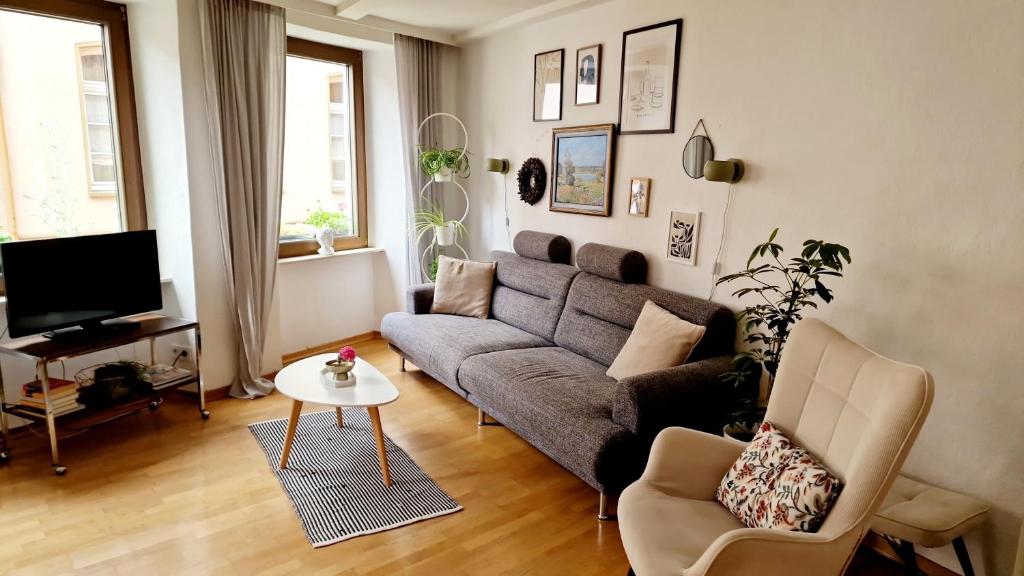 a living room with a couch and a tv at das rote Ferienhaus Terlinden in Lieser