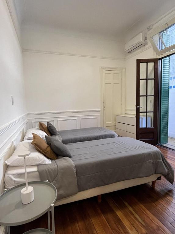 a bedroom with two beds and a table in it at Casa Lima Sur in Buenos Aires