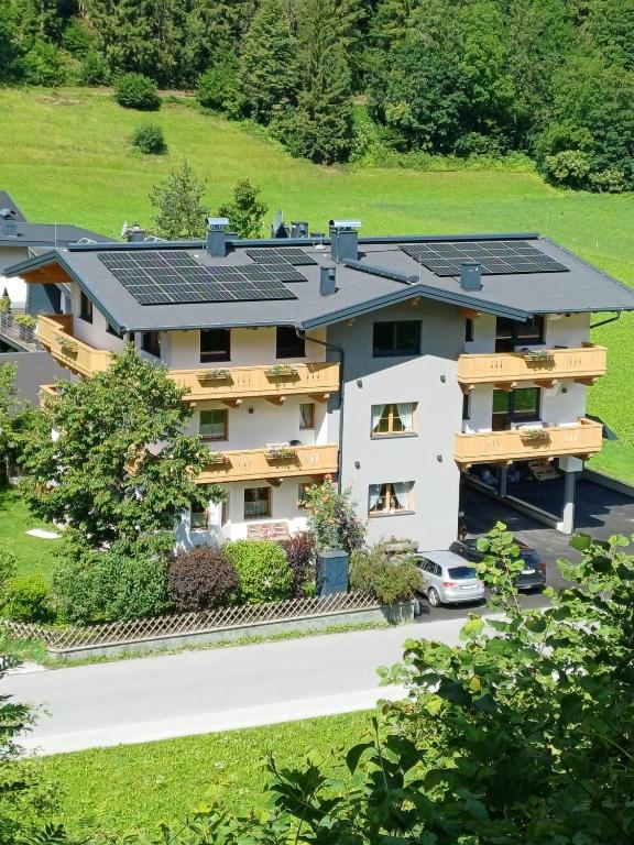 an apartment building with solar panels on the roof at Appartement Schroll in Schwendau