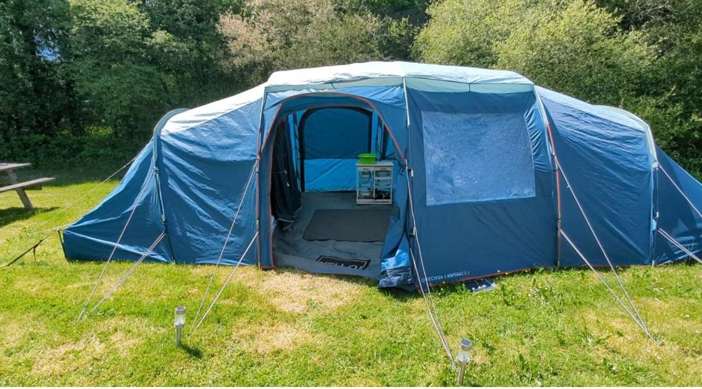 a blue tent sitting in the grass in a field at Fonclaire Holidays in Blond