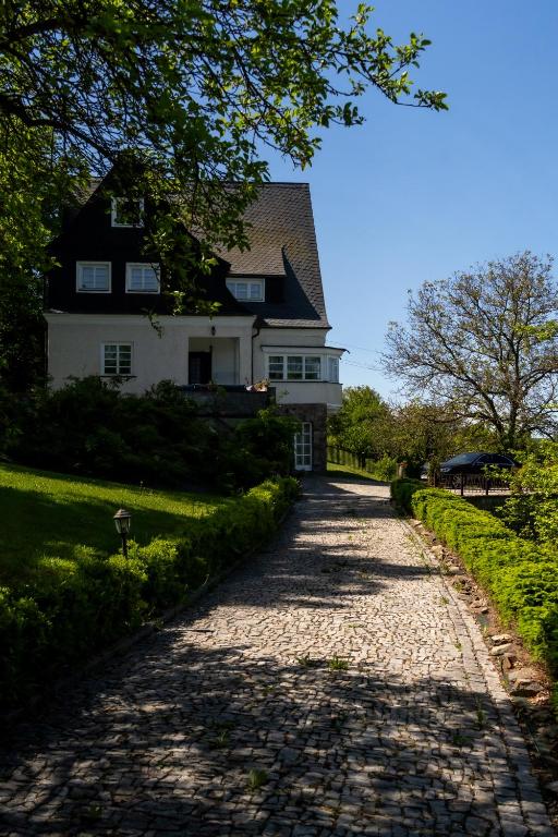 a cobblestone road in front of a house at Vila Vlasta in Bruntál