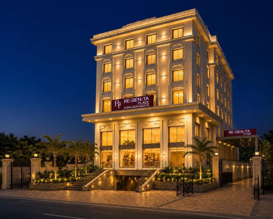 a large building with lights on it at night at Regenta Place Jhansi by Royal Orchid Hotels Limited in Jhānsi