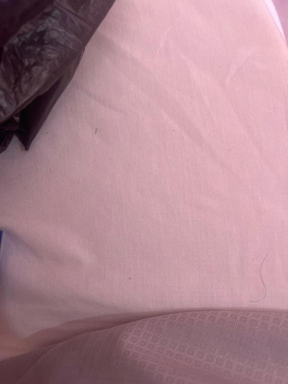 a close up of a pink bedsheet at Parnes luxury in Al Mudawwarah