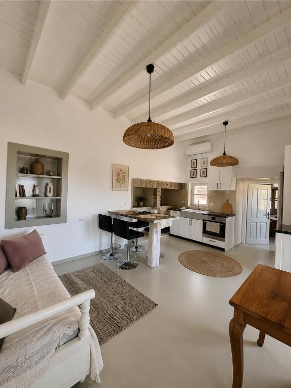 a living room with a couch and a table at Theochloe Patmos House in Patmos