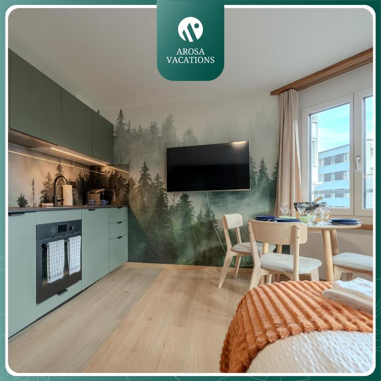 a kitchen with a table and a tv on a wall at Collina Forest Design-Studio by Arosa Vacations in Arosa