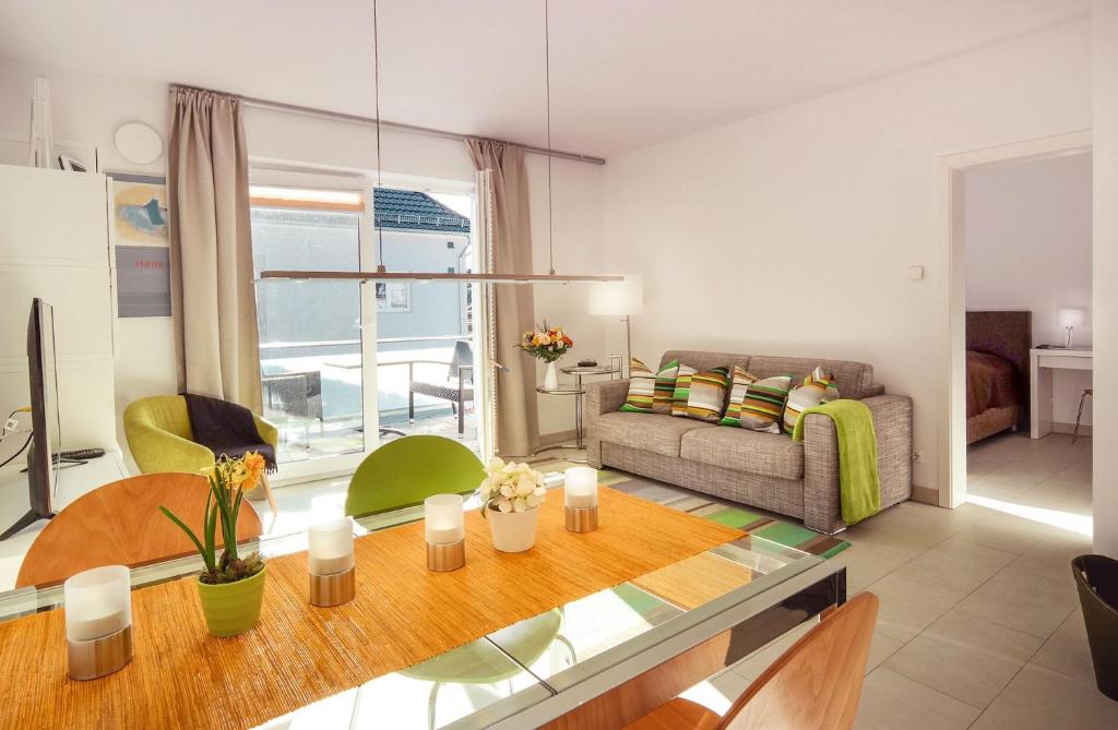 a living room with a couch and a table at Sonnentraum in Zinnowitz