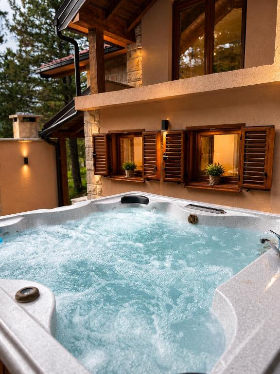 a hot tub in front of a house at Vikendica Ubla in Trebinje