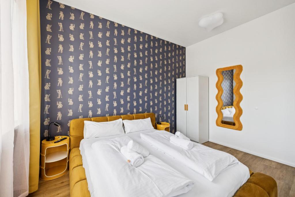a bedroom with a large bed with white sheets at Arbio I Cube Studios & Apartments St Pauli in Hamburg