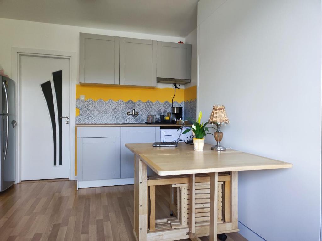 a kitchen with white cabinets and a wooden counter top at Lovely Studio with a Balcony in Sinemorets