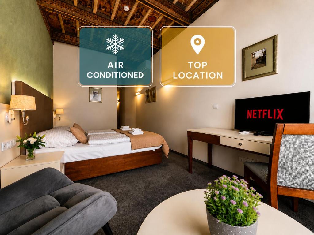 a hotel room with a bed and a top location sign at LH Hotel Golden Wheel in Prague