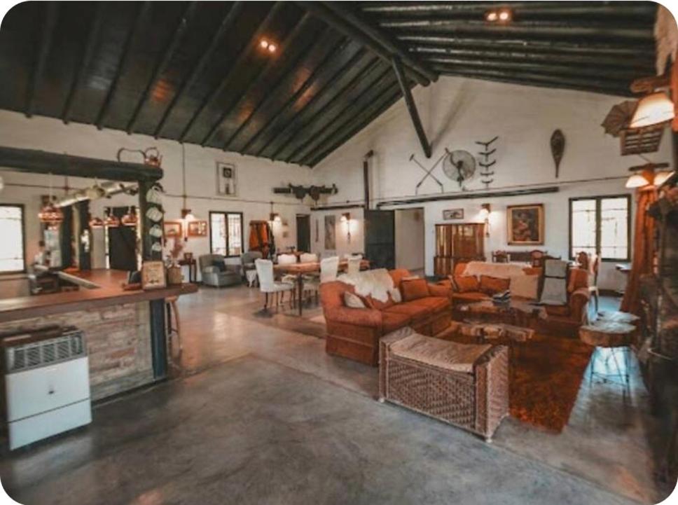 a large living room with couches and a fireplace at El Madejo - del Valle de Uco in Tunuyán